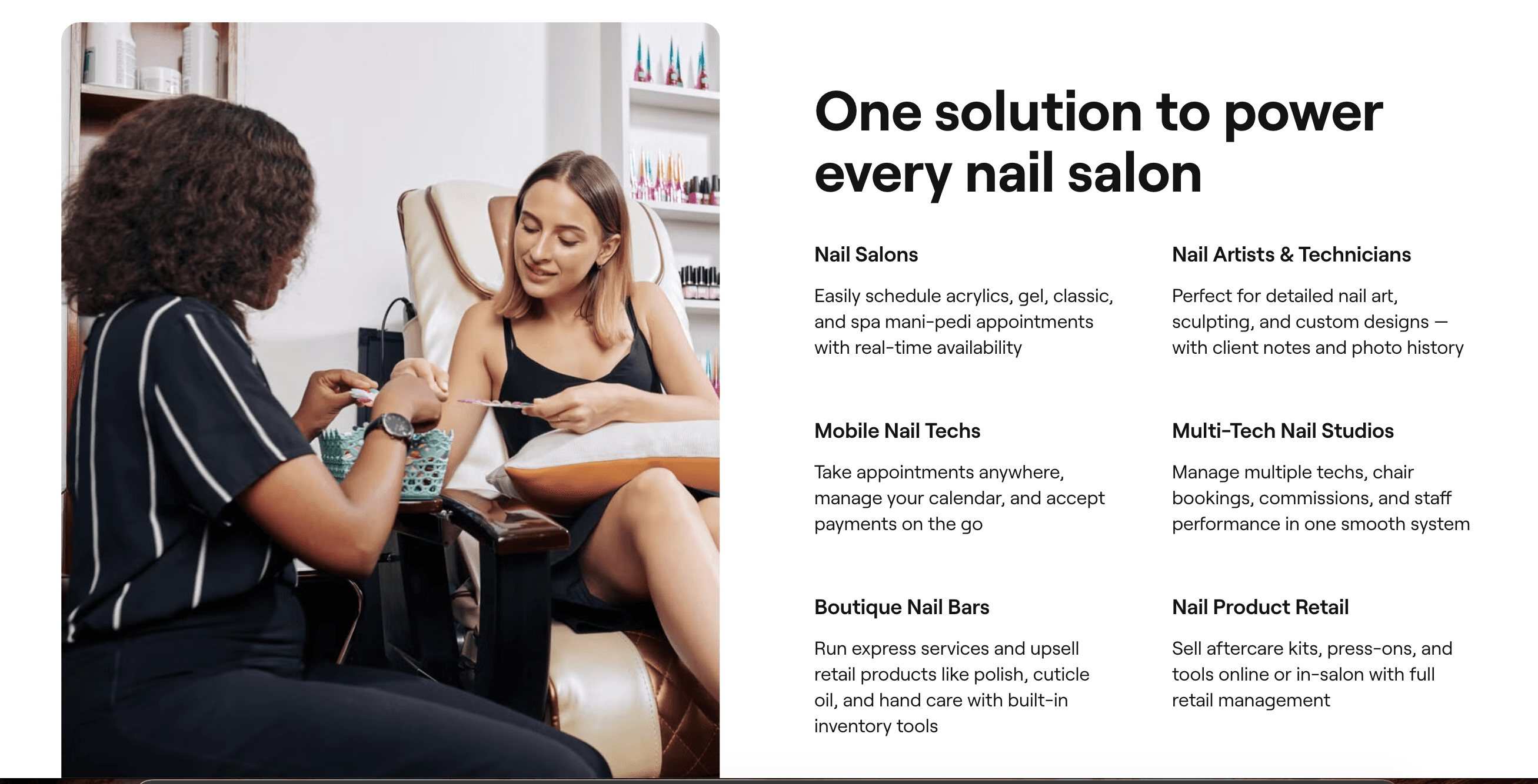 A nail technician helping a client choose a colour during a salon appointment
